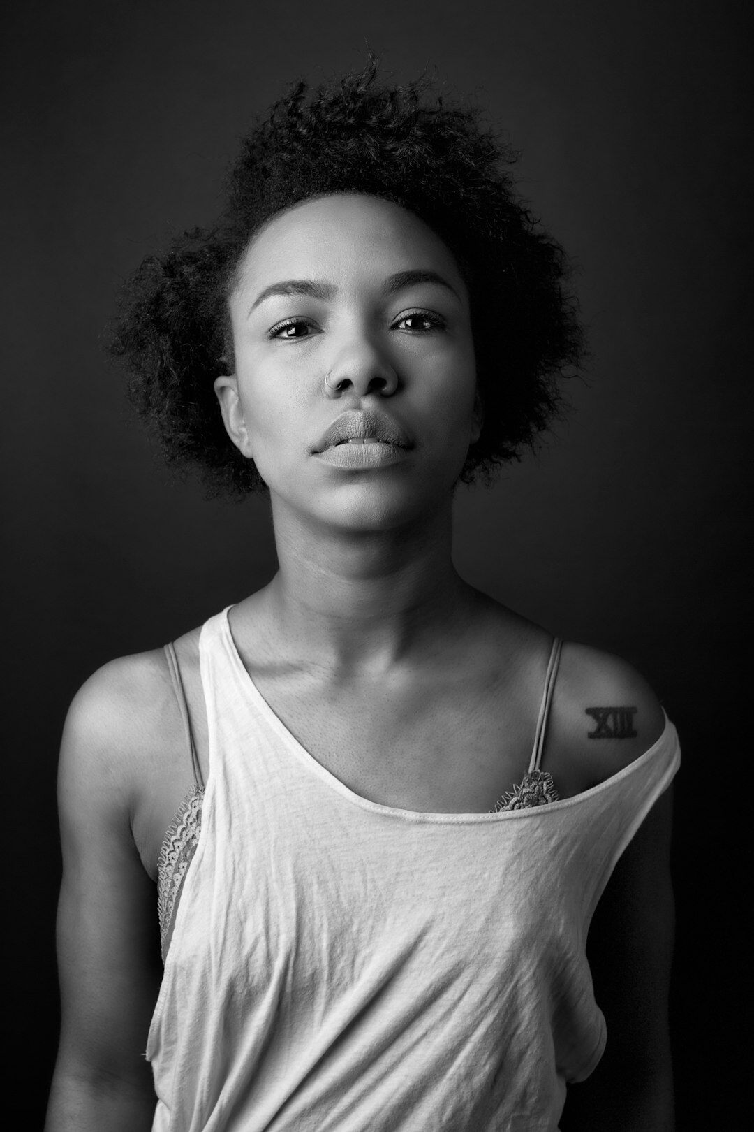 Studio portrait of a young woman with curly hair