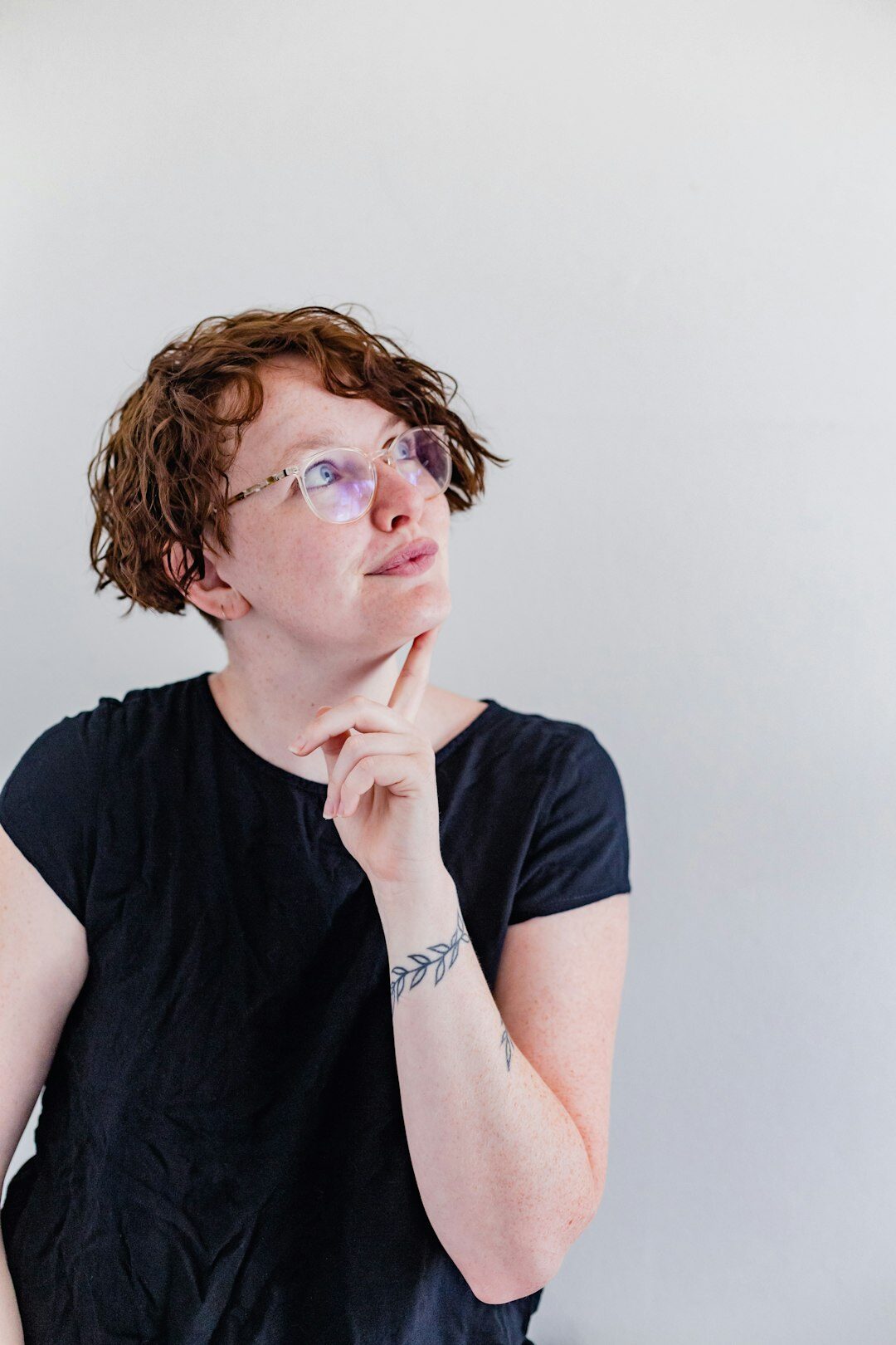 Studio portrait of a woman researcher with short hair and glasses