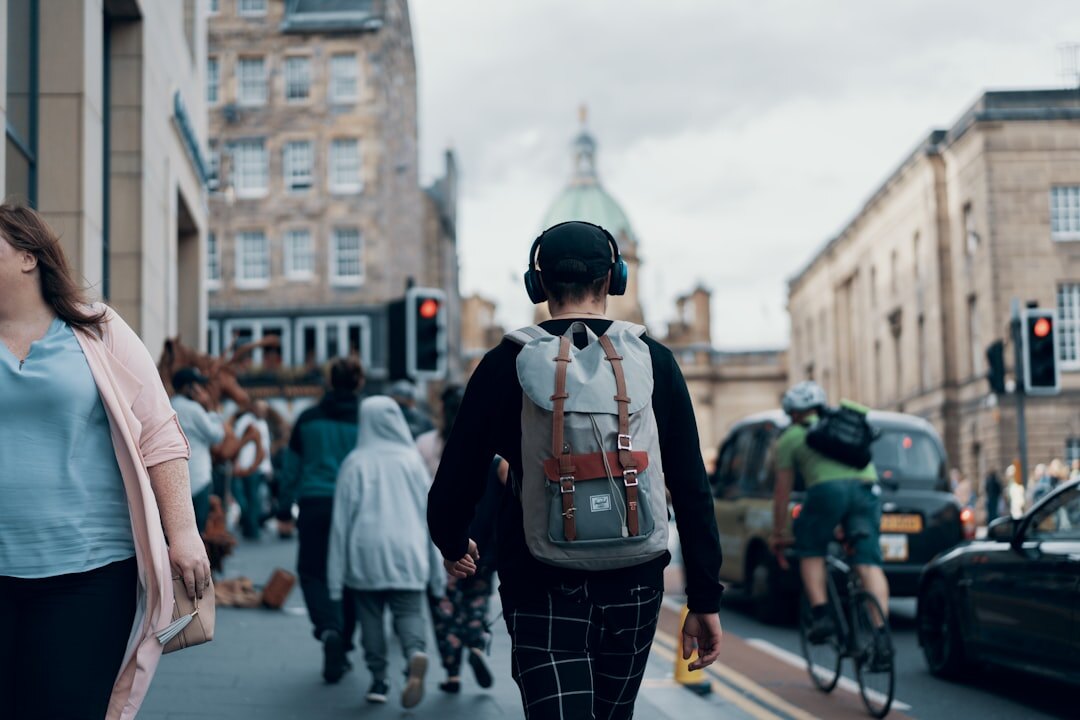 Crowd of pedestrians crossing a busy city street